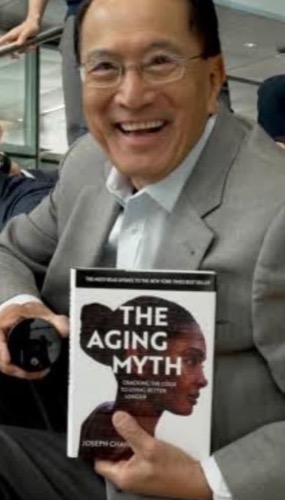Dr Joseph Chang holding his book, The Aging Myth